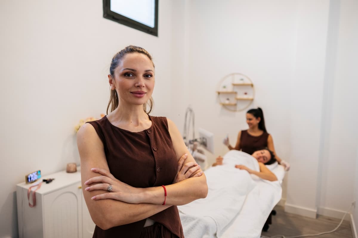 Lash tech setting up Google Business Profile on laptop in a New York lash suite