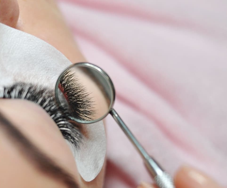 Close-up macro view of beautiful lash extensions on an eye, showing detailed craftsmanship and volume