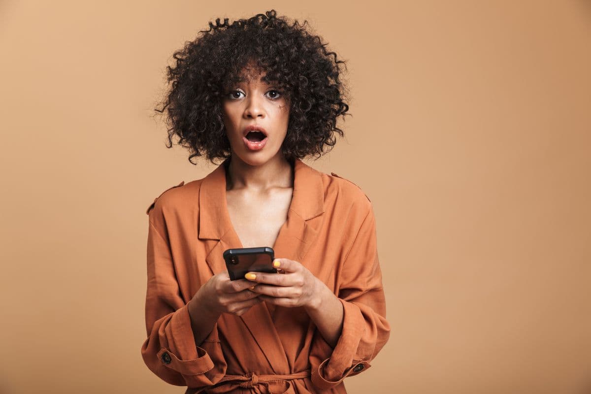 Lash artist looking at her phone in frustration after her Instagram account goes down