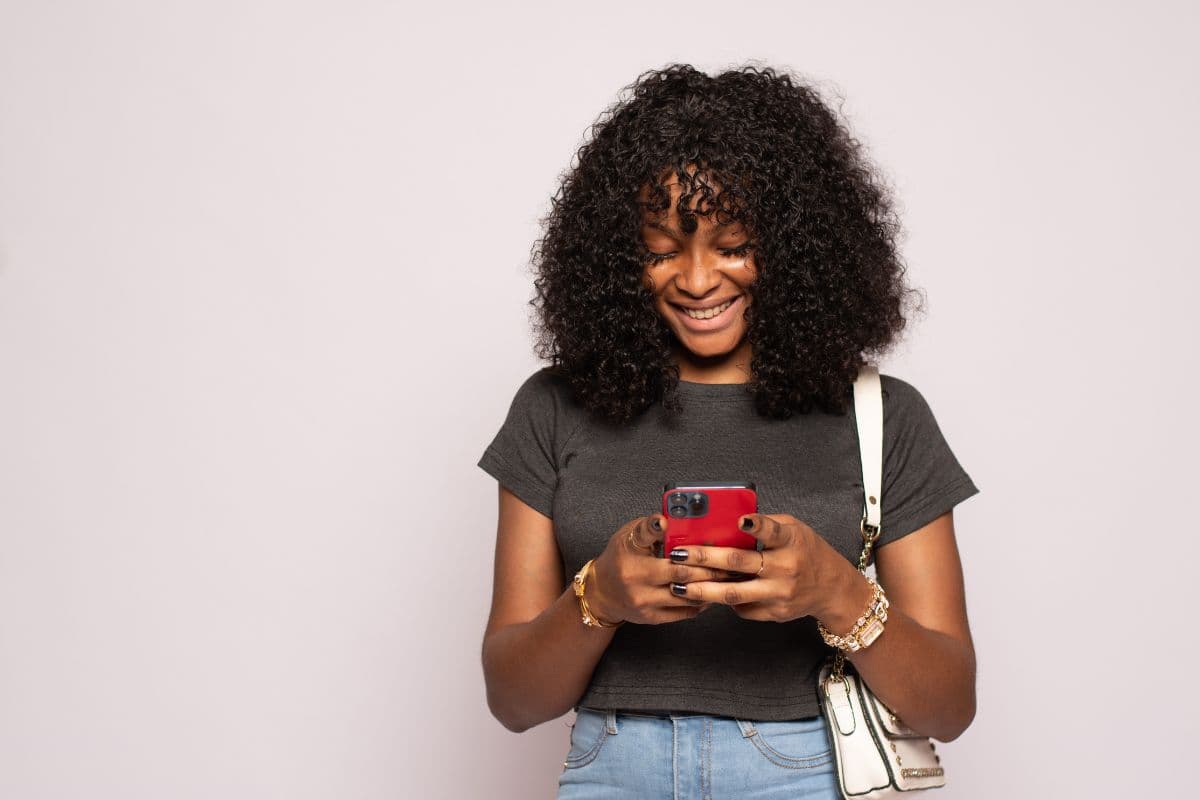 Solo lash tech setting up her SuiteCal online booking page on her phone, customizing services and hours between appointments