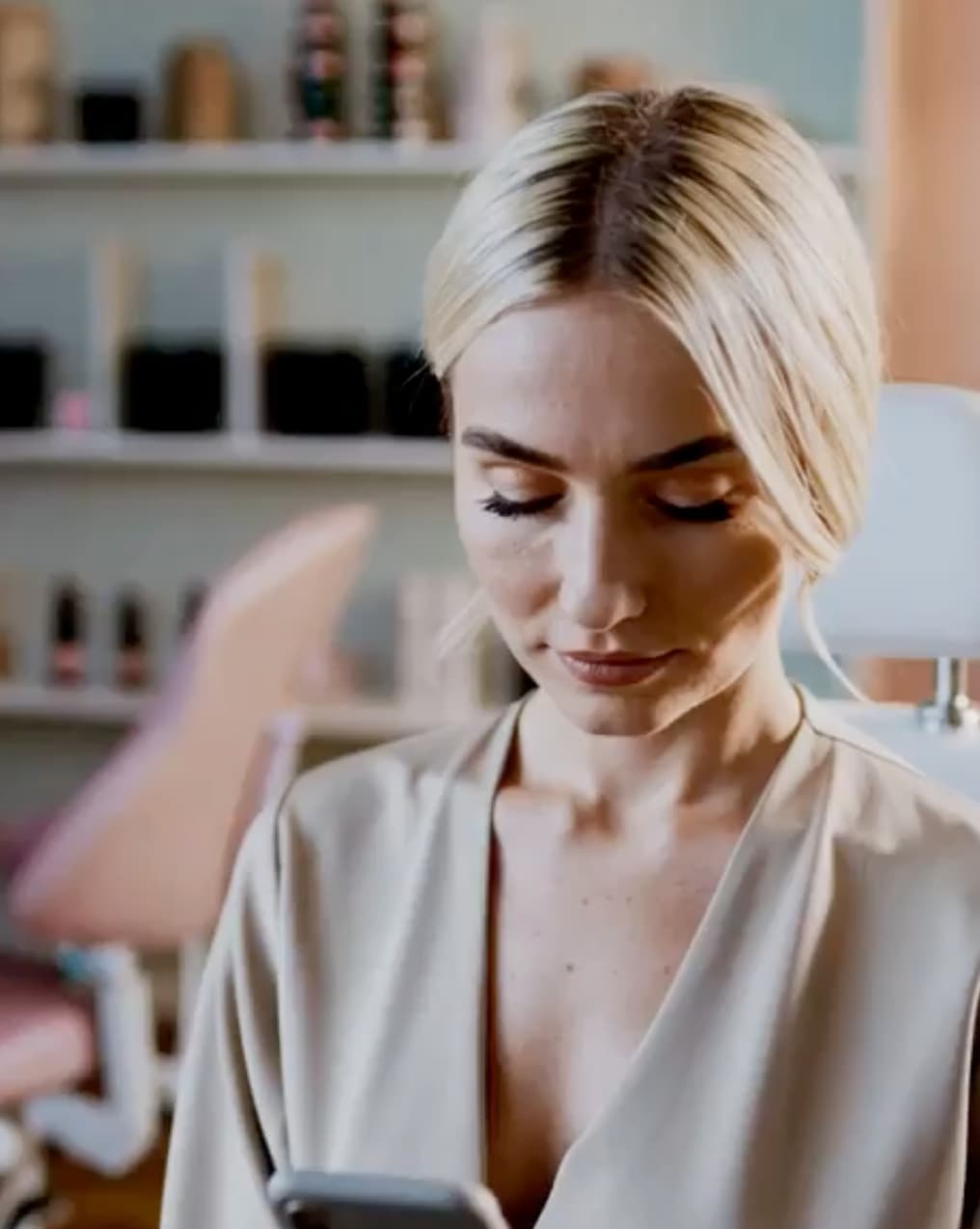 Lash artist checking mobile phone for bookings