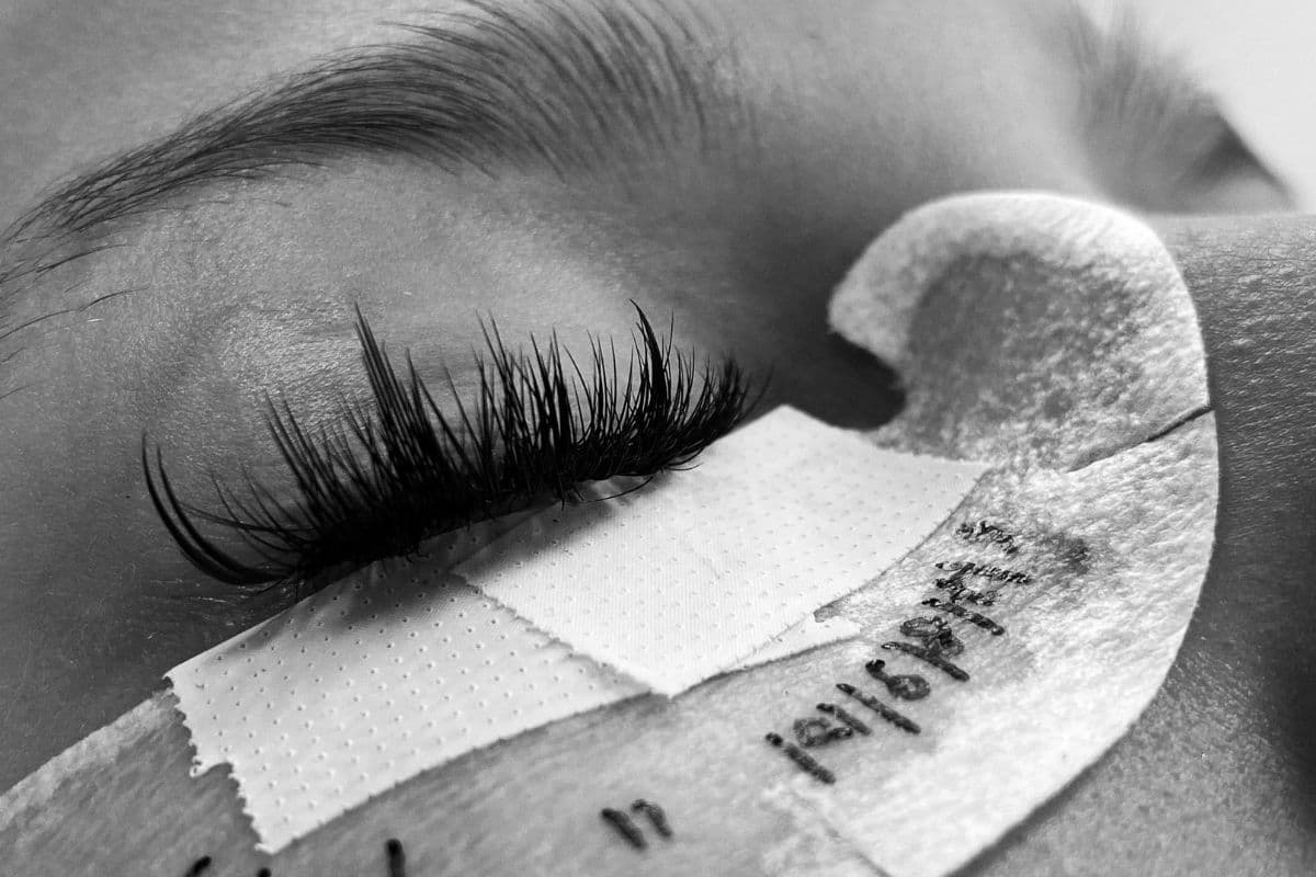 Lash extension appointment in progress during a professional lash service Close-up of a lash extension appointment in progress, showing detailed lash application work on a client during a professional lash service.